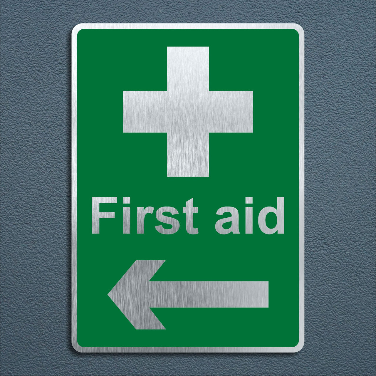 First Aid Sign with a Left Pointing Arrow in a Brushed Aluminium Finish